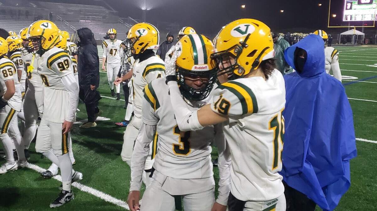 Vanden’s Chris Clark (19) hugs teammate Jamarion Grace (3) after the Vikings defeated West Park, 14-7, Friday in Roseville in a Sac-Joaquin Section Division III semifinal.