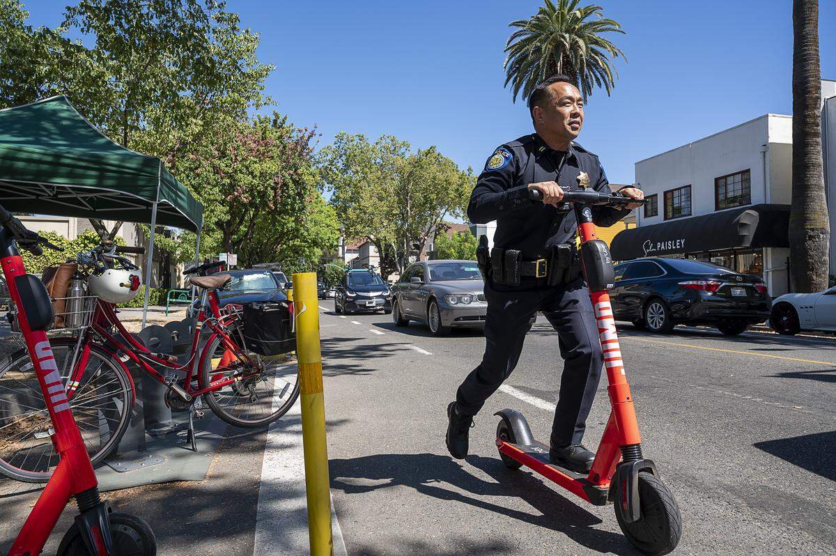 Sacramento Police Captain Norm Leong rides an eScooter as the city hosts an educational pop-up on shared bike and scooter safety at 24th and K streets on July 24, 2019, in Sacramento. Public safety has become a priority for both riders, commuters, and city officials.