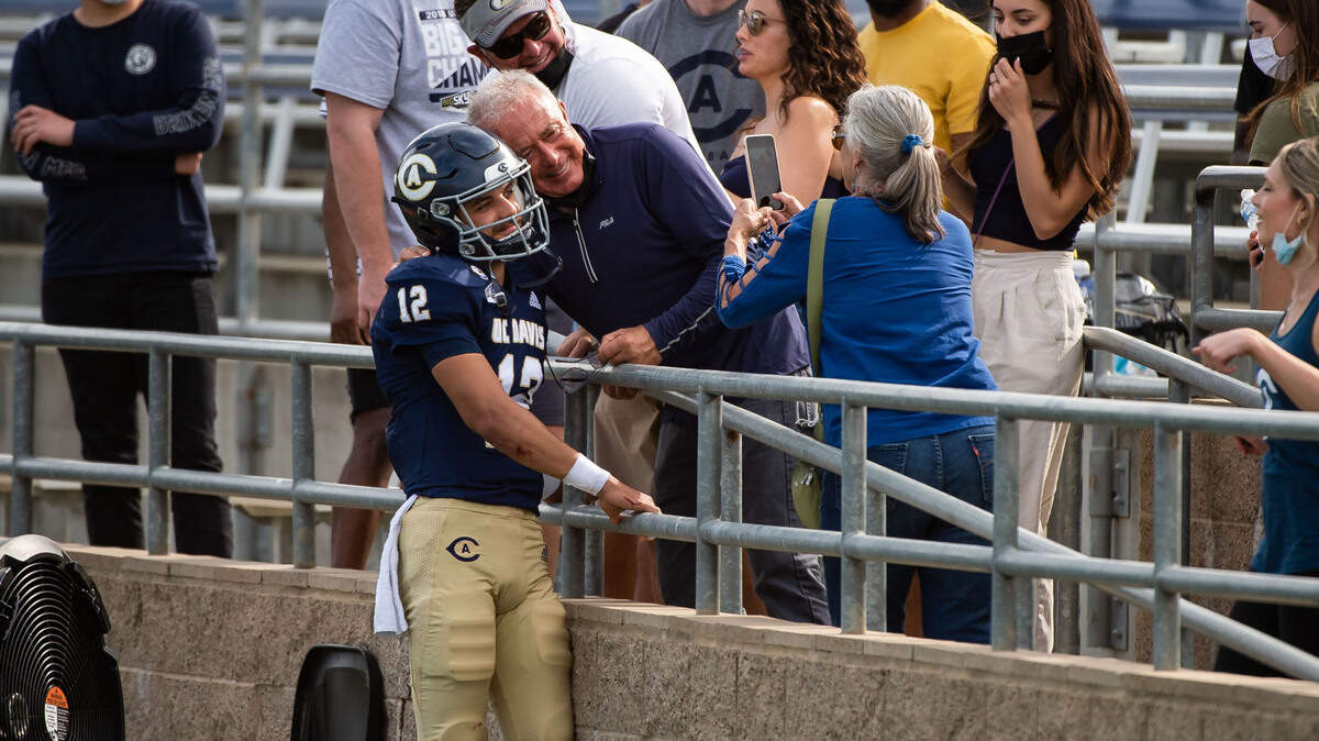 UC Davis Aggies quarterback Hunter Rodrigues (12) stands for a photo with his grandfather visiting from Southern California, Bart Berardo, after the Aggies’ 32-22 loss to Eastern Washington at the college football game Saturday, April 3, 2021, at UC Davis Health Stadium. It was the first game open for fans and last home game of the season for the Aggies.