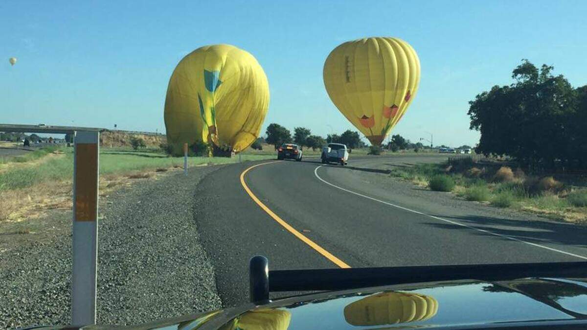 A pair of hot air balloon made emergency landings Friday morning on the shoulder of Interstate 505 near Winters, authorities said.