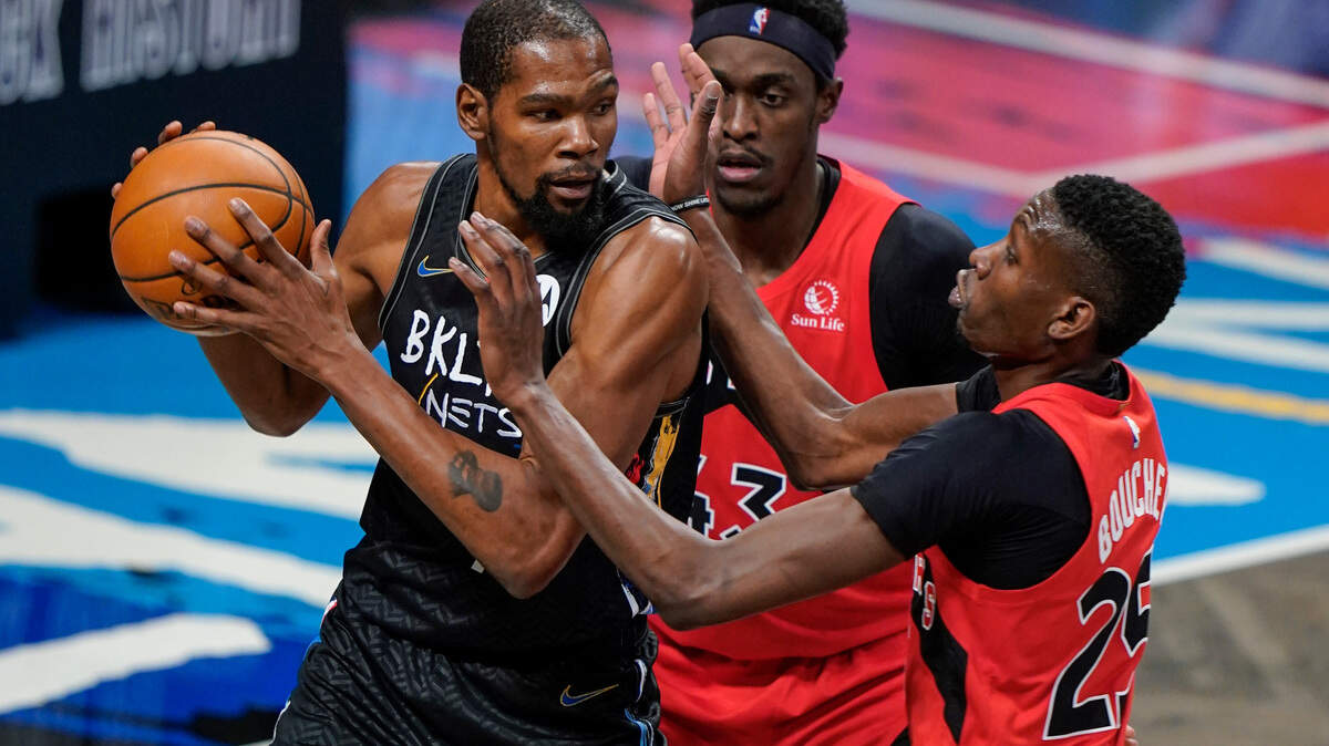 Toronto Raptors’ Pascal Siakam (43) and Chris Boucher (25) defend against Brooklyn Nets’ Kevin Durant (7) during the first half of an NBA basketball game Friday, Feb. 5, 2021, in New York. (AP Photo/Frank Franklin II)
