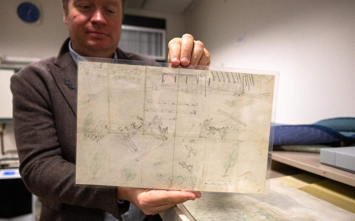 Alex Vassar, the California State Library’s chief spokesperson, presents on Thursday one of his favorite items in the library vault – a rudimentary pencil sketch by John Marshall. “I have found it” says a speech bubble in the illustration of the Sutter’s Mill site where Marshall made the 1848 discovery that started the state’s Gold Rush. 