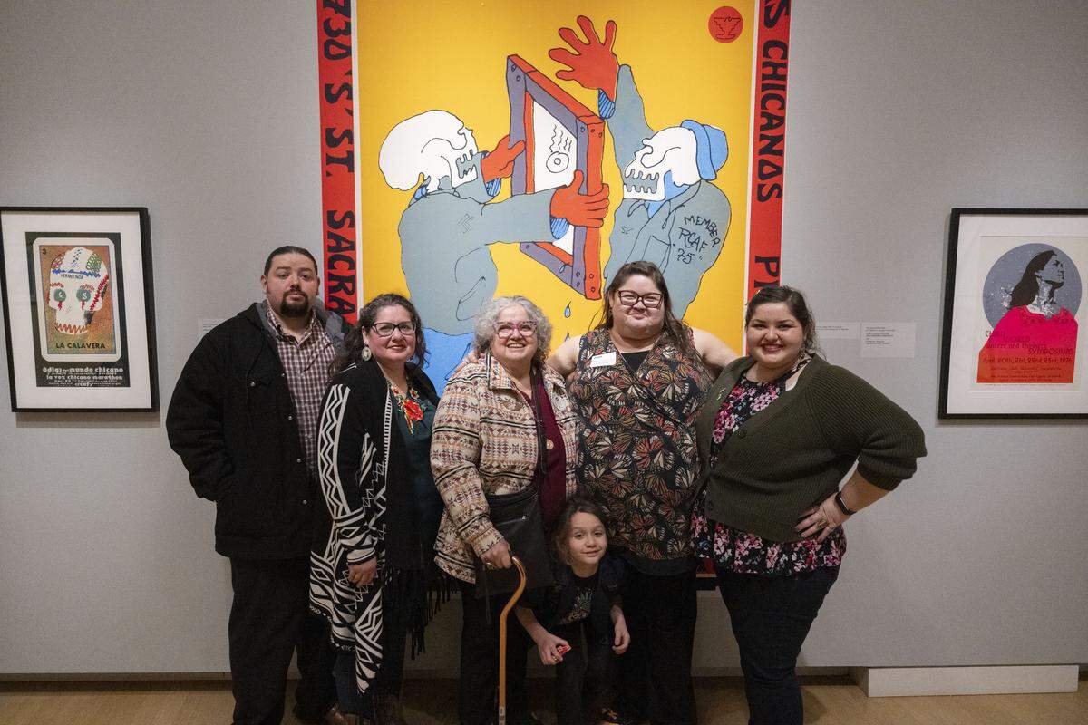 Family members of the late Ricardo Favela stand in front of some his art work at the “Rebels With La Causa: Royal Chicano Air Force Art and Activism, 1970-1990,” at the Crocker Art Museum on Friday.