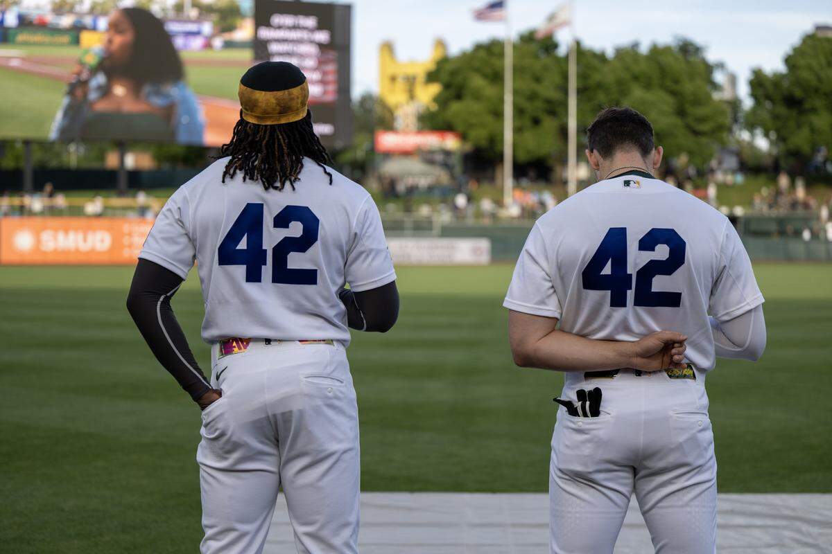 Athletics Shea Langeliers, on right, and Lawrence Butler don the No. 42 on Jackie Robinson Day before playing the Texas Rangers at Sutter Health Park on Wednesday in West Sacramento.