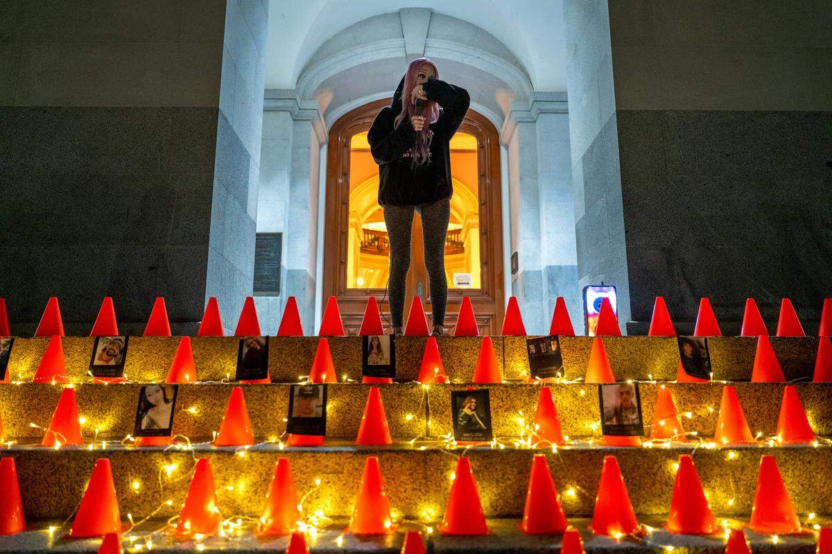 Erika Pringle pauses emotionally while speaking about her brother Andrew Pringle at a vigil she organized on the World Day of Remembrance for Road Traffic Victims at the state Capitol on Nov. 16. Andrew, pictured below center, was killed in 2023 when a driver ran a red light while he rode his skateboard. Erika organized the event to support other victims of what she calls “vehicular homicide.”