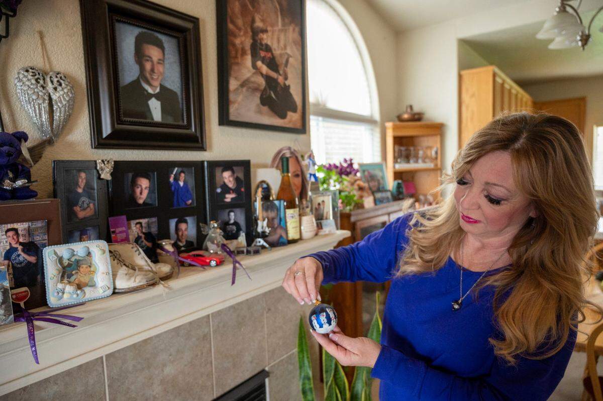 Francine Turner holds a Christmas ornament with snowmen made by her son Tyler’s fingerprints while remembering him on his birthday in February at home in Los Banos. Tyler died while skydiving in 2016.