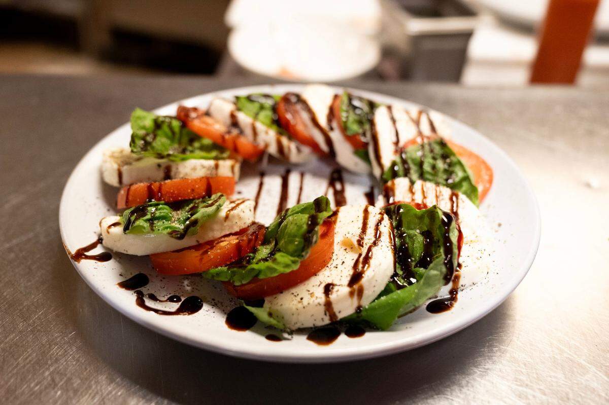 Fresh burrata cheese, served with tomato, basil, arugula and topped with a balsamic glaze, is served at Ippolito’s Trattoria in Rosemont earlier this month.