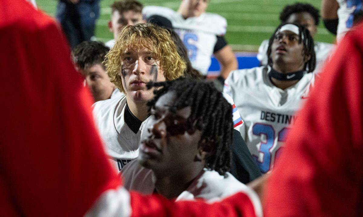 Destiny Christian Lions quarterback Dallas Munn (1) listens to co-head coach Aaron Garcia speak to the team after its victory over Christian Brothers in a Sac-Joaquin Section Division III quarterfinal game on Friday, Nov. 15, 2024, in Sacramento.