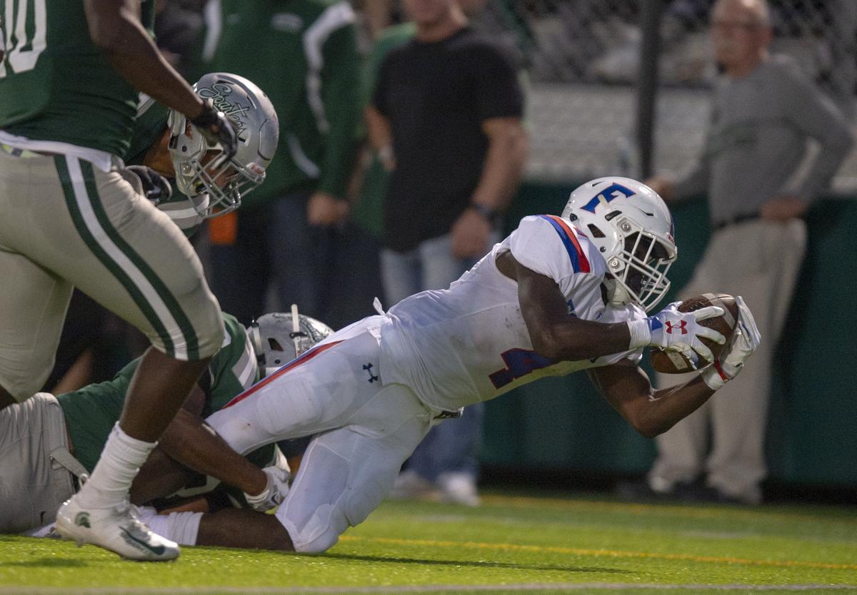 Folsom Bulldogs’ Daniyel Ngata touches his knee to the turf short of the goal line before losing the football in the second quarter against De La Salle on Friday in Concord.