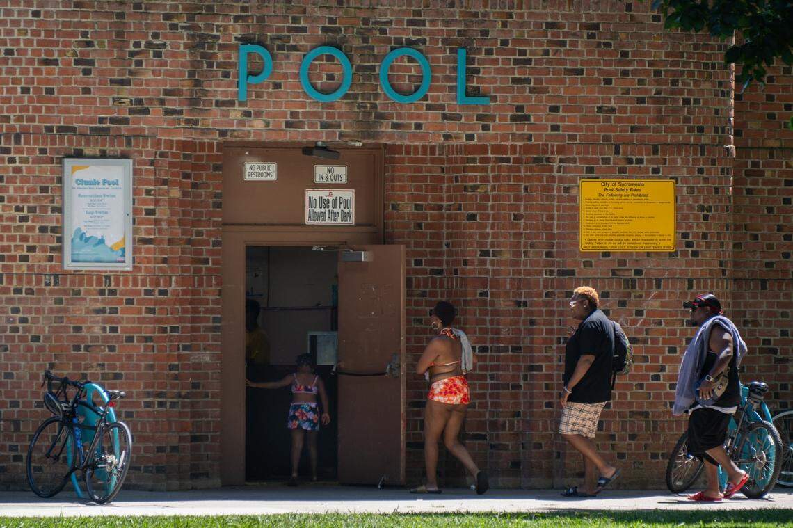 People enter Clunie Pool at McKinley Park in East Sacramento on a 103-degree day last year. 
