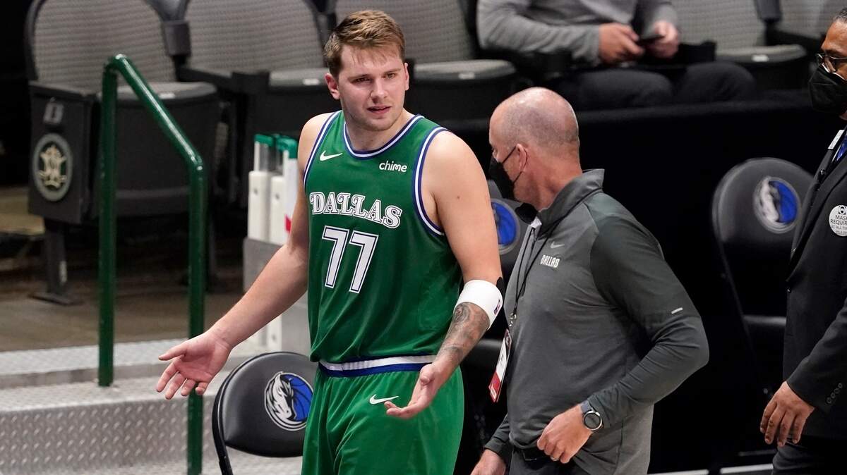 Dallas Mavericks guard Luka Doncic (77) talks with a team staff member as he walks off the court after being ejected late in the second half of an NBA basketball game against the Sacramento Kings in Dallas, Sunday, May 2, 2021. (AP Photo/Tony Gutierrez)