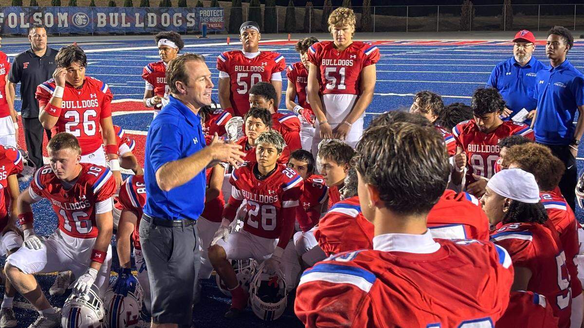 Folsom Bulldogs football coach Paul Doherty talks to his team after a 49-7 win over Sacred Heart on Friday in Folsom.
