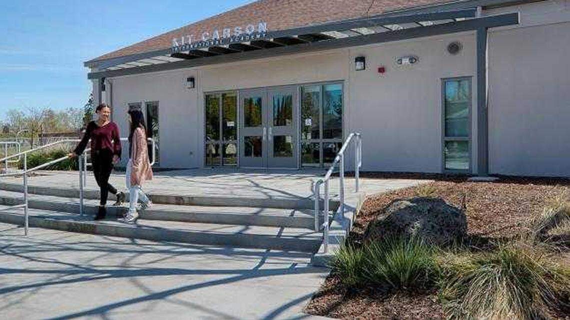 Two students from Kit Carson International Academy were suspended after officials say they passed around fake dollar bills with racial slurs and imagery.