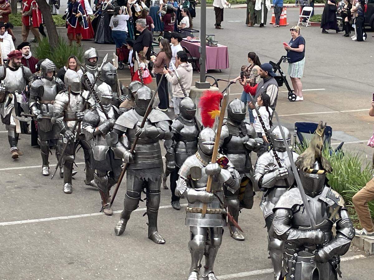 Actors and volunteers playing Knights of the Realm march into the Folsom Renaissance Faire on Sunday, Sept. 28, 2025. The nonprofit event is in its 33rd year in Folsom.