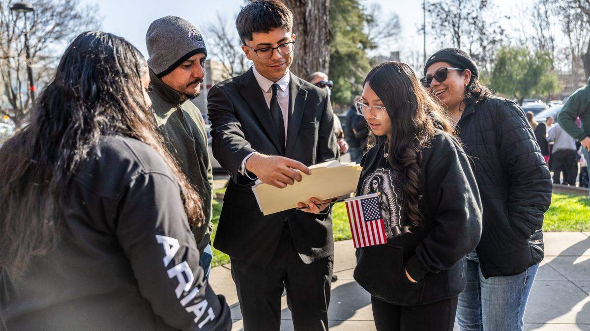 Lathrop resident Hector Arreola shares his naturalization certificate with his family as more than 800 people took the oath to become U.S. citizens on Wednesday, Jan. 29, 2025. Arreola, of Jalisco, Mexico, is the first in his family to get his citizenship and his parents and sisters hope to follow in his path.   
