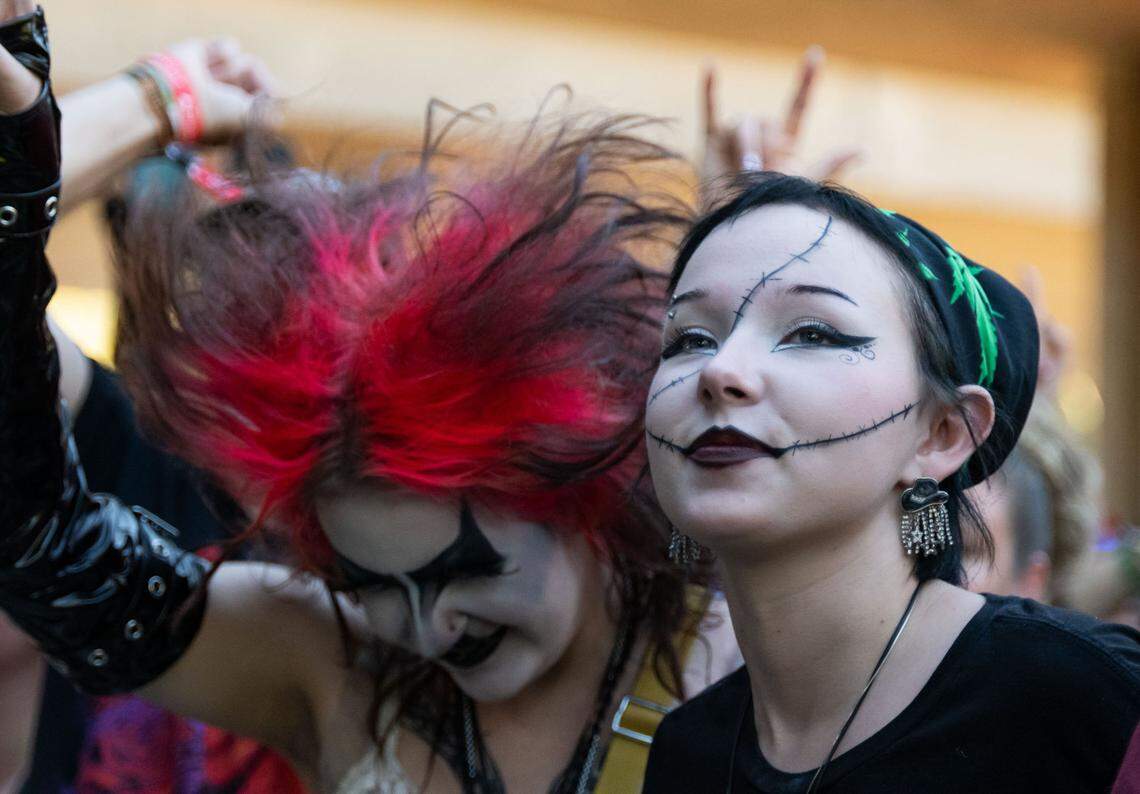 Two friends enjoy metalcore band Shadows Fall at the Aftershock festival in Sacramento’s Discovery Park in 2024. 