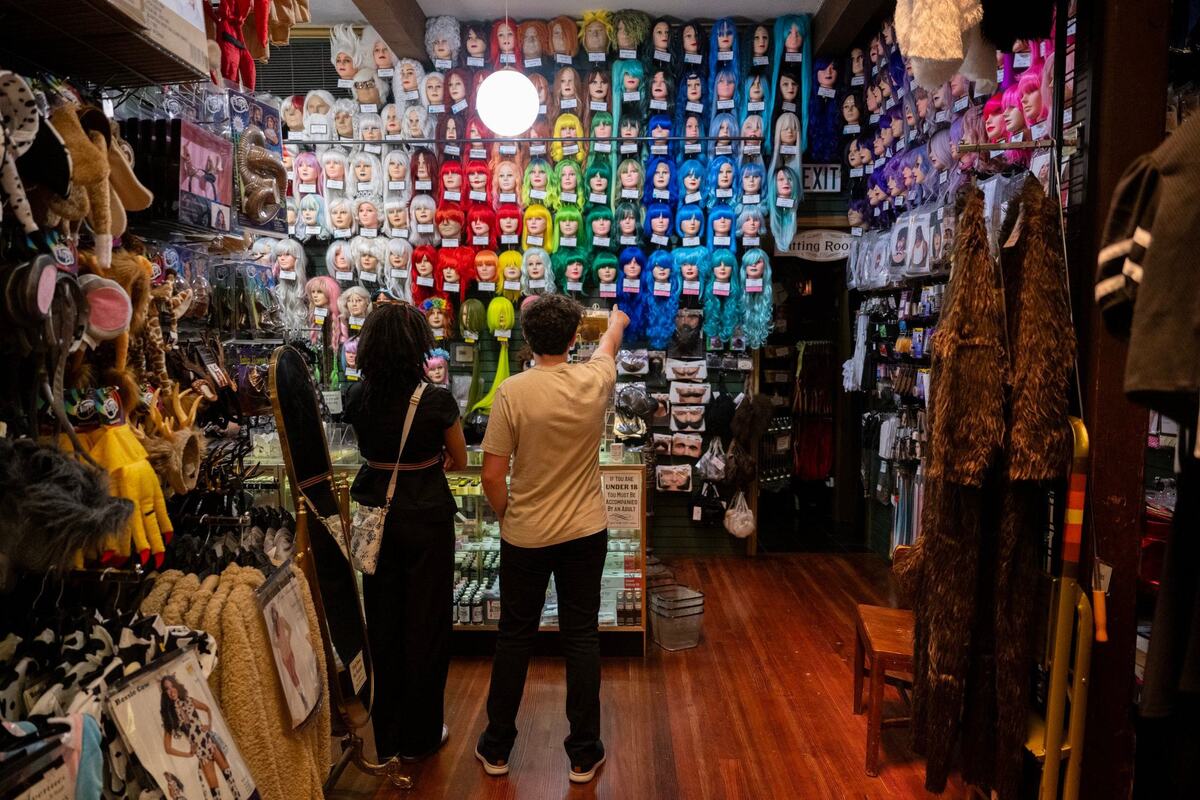 Customers view colorful wigs displayed at Evangeline’s on Wednesday in Old Sacramento.