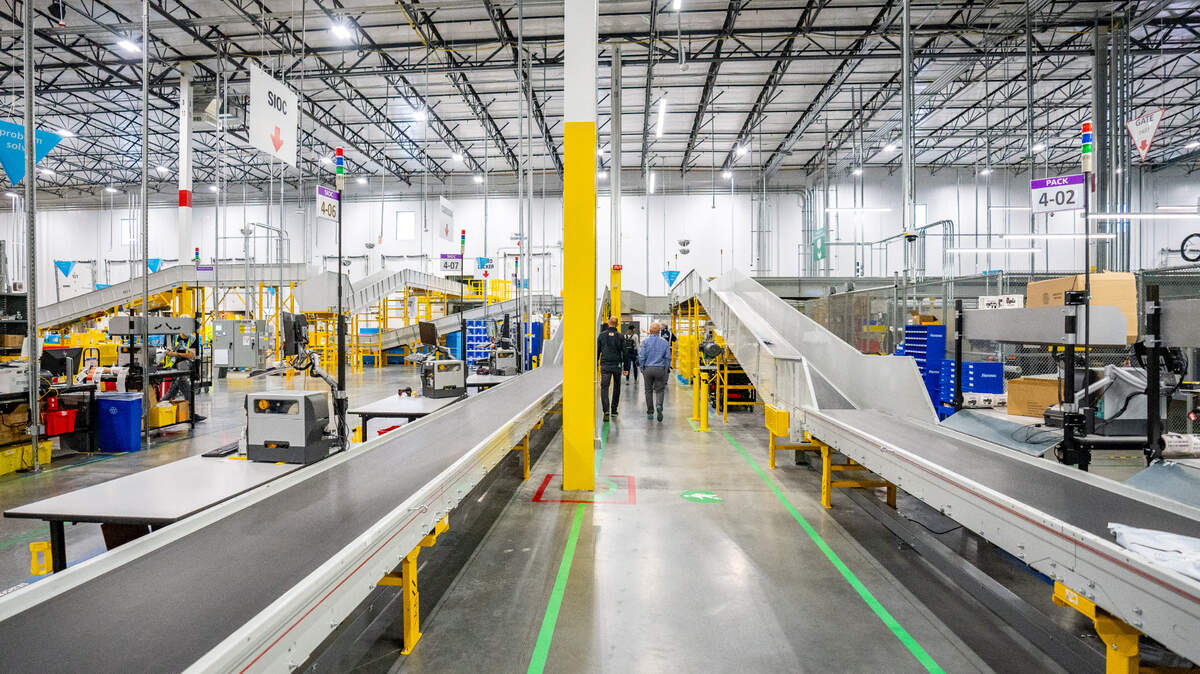 Conveyor belts run throughout the the Amazon Sacramento region same-day delivery center, moving packages from one station to the next on October 26, 2022.