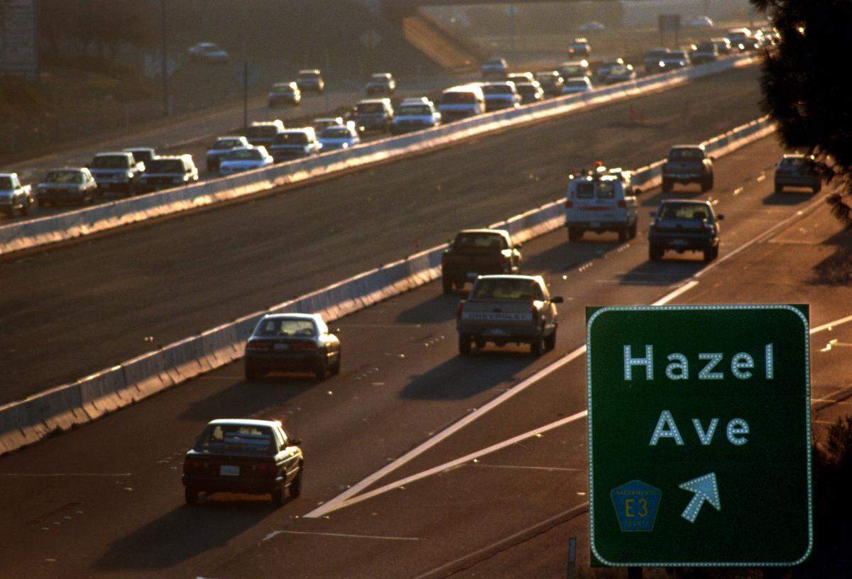 As the sun sets, eastbound traffic (left) becomes congested along Highway 50 near the Hazel Avenue exit on Wednesday, January 5, 2000. 