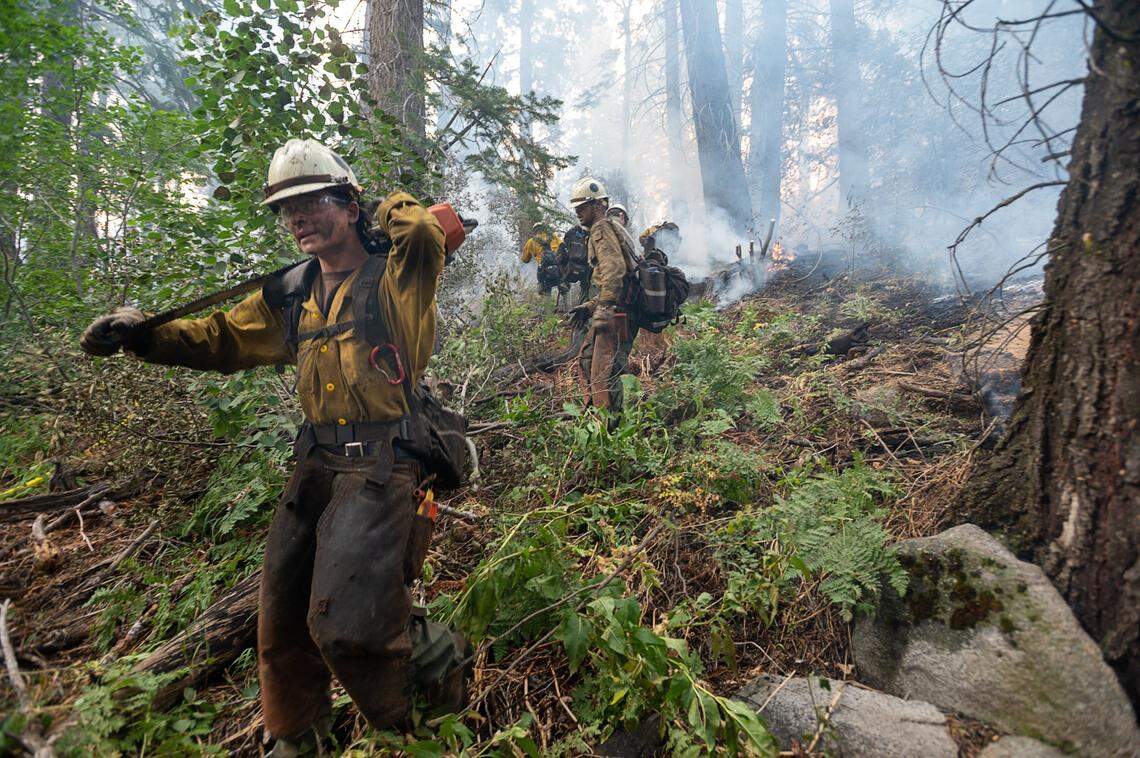 El Dorado county firefighters protect homes on Snowflake Drive in Christmas Valley on Tuesday, Aug. 31, 2021, after the Caldor Fire burned into the South Lake Tahoe Basin.
