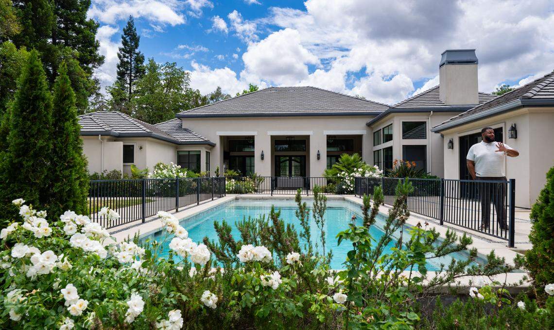Listing agent Kelly Pleasant stands near the centerpiece pool in the backyard of the former home of NBA star De’Aaron Fox on Monday, May 12, 2025.