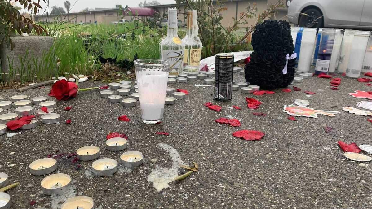 People created a makeshift memorial with candles, rose petals and other items outside the Royal Castle Banquet Hall, where two men were killed and five other people were injured in a shooting Saturday Oct. 30, 2021, during a large Halloween party in Sacramento County, California.
