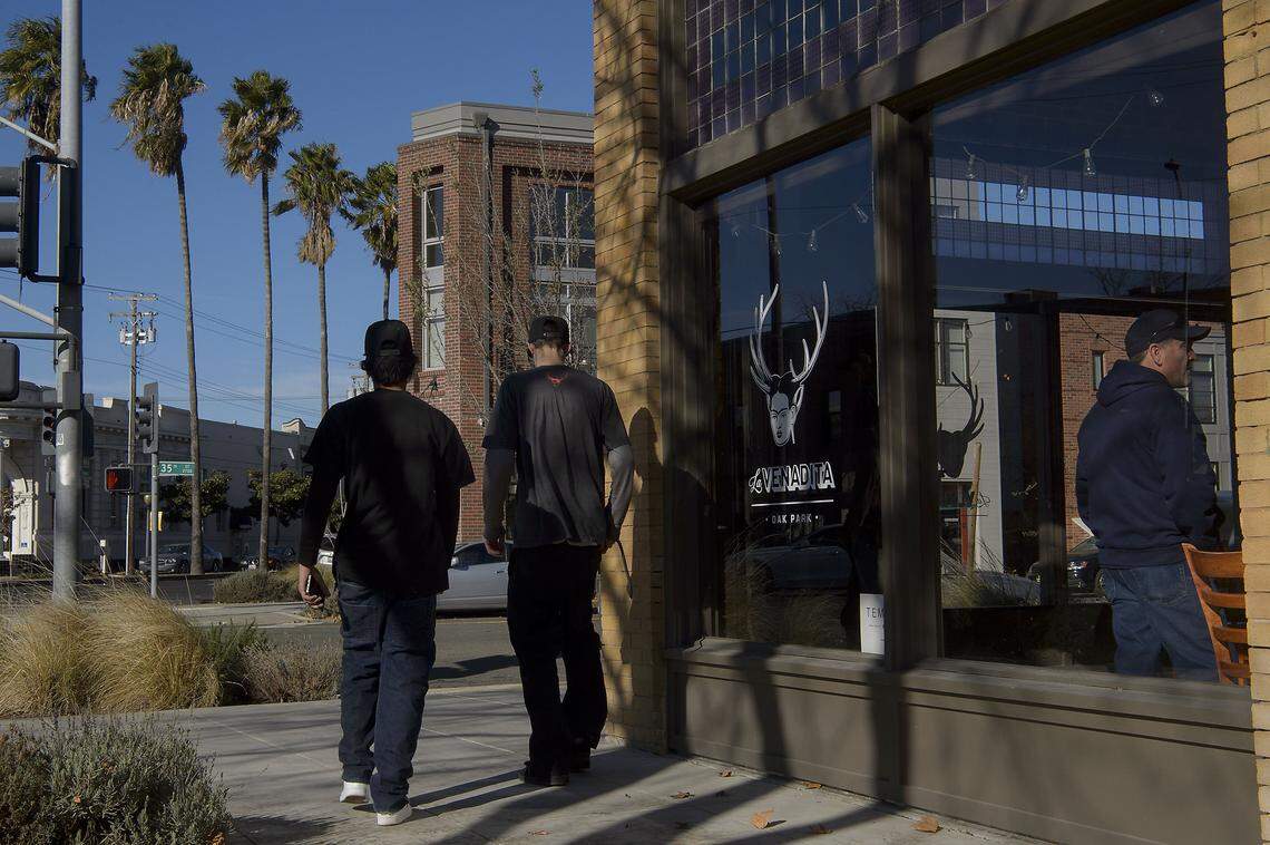 Customers patronize the small businesses along Broadway in the Oak Park area known as the Triangle District in Sacramento on Saturday, December 16, 2017.