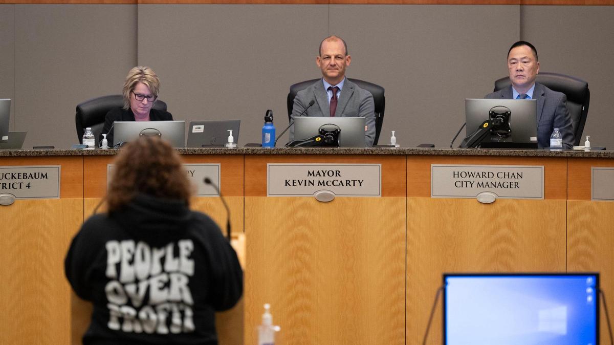 Sacramento Mayor Kevin McCarty and City Manager Howard Chan listens to Andrew Bianchi as he urges the City Council not to retain extend Chan’s contract on Tuesday, Dec. 17, 2024. The council voted 6-3 against the extension.