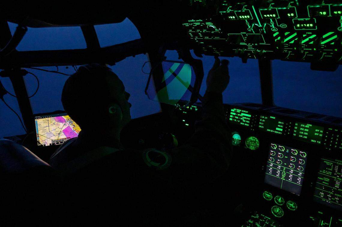 Maj. Peyton Eustis, pilot for the U.S. Air Force Reserve 53rd Weather Reconnaissance Squadron “Hurricane Hunters,” adjusts controls during flight on the WC-130J Super Hercules in January 2023 over the Pacific Ocean. The crew’s 10-hour flight collects data that improves understanding of storm conditions, enabling better forecasts.