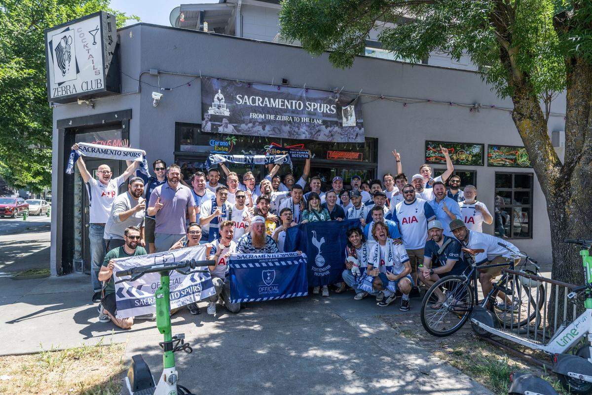 Fans of Tottenham stand for a photo during halftime at the Zebra Club in Sacramento as their team leads Manchester United during the Europa League championship game on Wednesday.