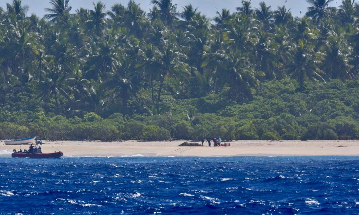 Their boat was damaged, the Coast Guard said, leaving them stranded on the island.