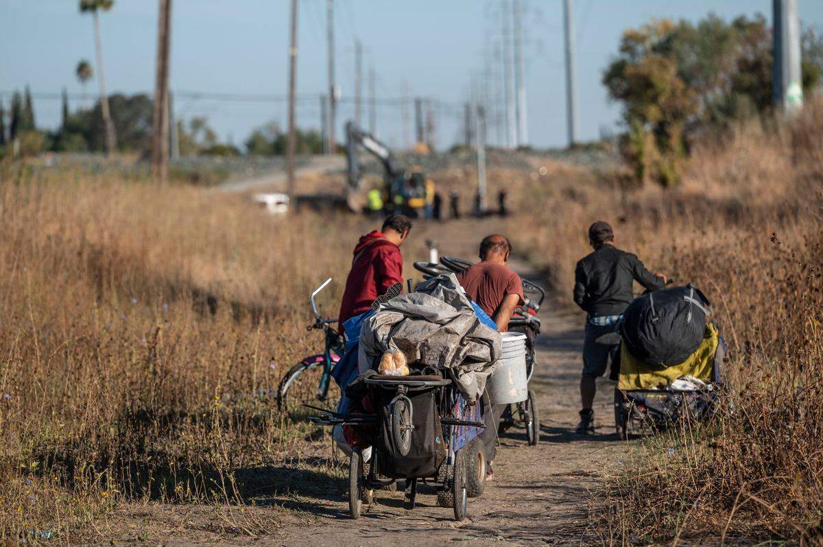A group of homeless people living on Morrison Creek in south Sacramento leave their longtime camp on Oct. 6 as it’s dismantled so the Department of Utilities can begin levee work.