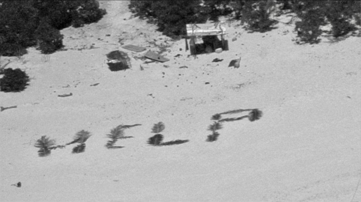 Three men were stranded for more than a week on a remote Pacific atoll before rescuers saw their message in palm fronds, the U.S. Coast Guard said.