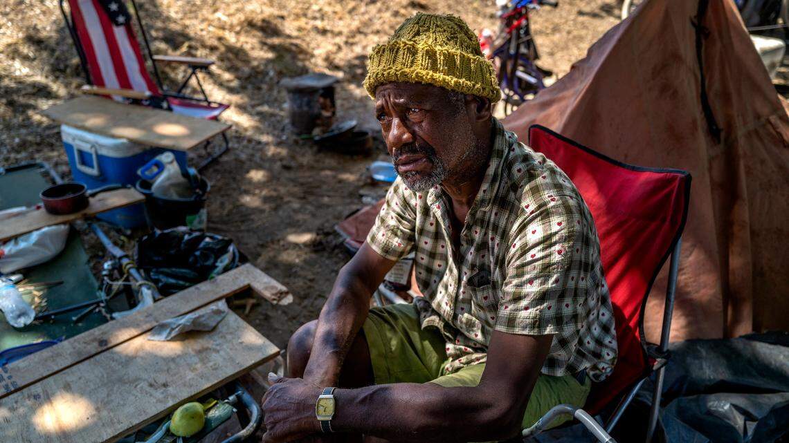 Eugene Williams, 63, contemplates moving from a tent along Lathrop Way in Sacramento on Friday. He was trying to decide if it would be safe for him to move to the city of Sacramento Safe Ground for homeless at Miller Park. “Do they have security there? Are they going to be smoking? Because I can’t take smoking,” said Williams, who suffers from a variety of health issues.
