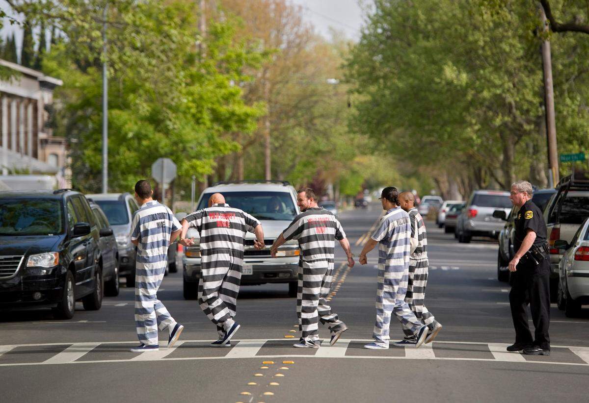 In-custody defendants in chains are led across 3rd Street toward the historic Yolo County Courthouse in Woodland in 2011, before the construction of a replacement courthouse.