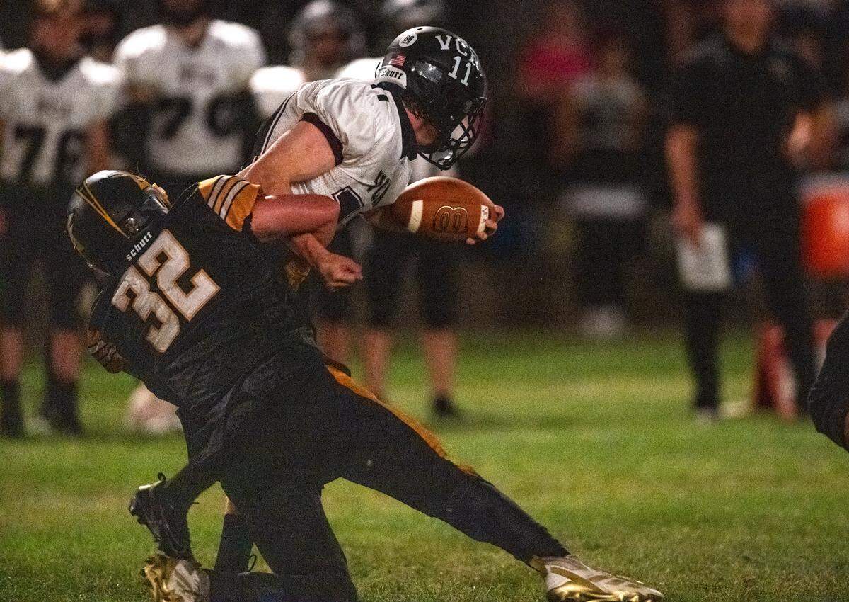 The Delta Saints' Jax Soto (32) sacks the Valley Christian Lions’ Connor Tinker (11) during the first half of an 8-man football game in Clarksburg on Friday.