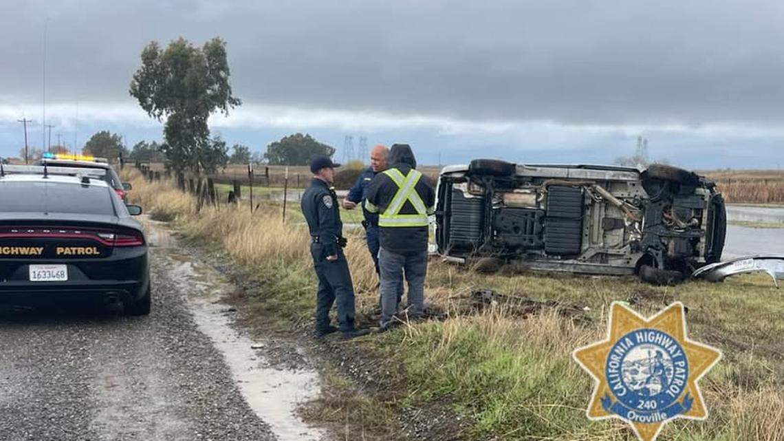 Officers stand near a rolled minivan Saturday, Dec. 15, 2024, after it flipped off of Nelson Road near Oroville. The vehicle’s 11-year-old driver crossed a flooded section of the road and lost control as CHP followed him.