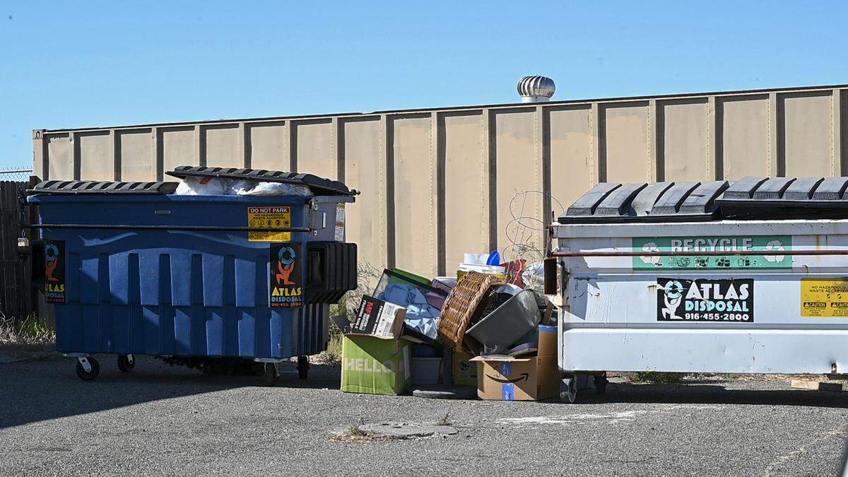 Animal beds and habitats sit piled next to overflowing garbage bins outside Wildlife Care Association on Wednesday.