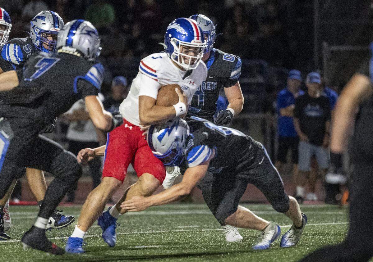 Folsom High School quarterback Ryder Lyons (3) drives in for a touchdown during a high school football game against Rocklin High School on Friday in Rocklin.