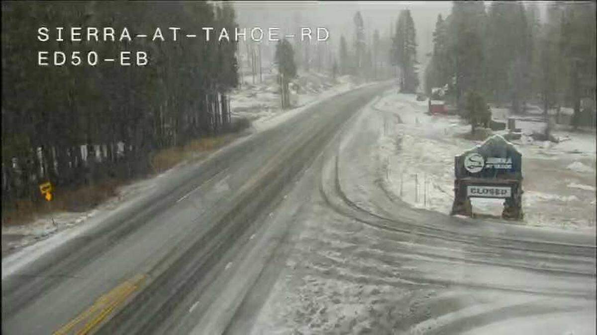 Snow falls along Highway 50 at Sierra-at-Tahoe resort in El Dorado County, as seen from a Caltrans traffic camera on Wednesday, Dec. 24, 2025.