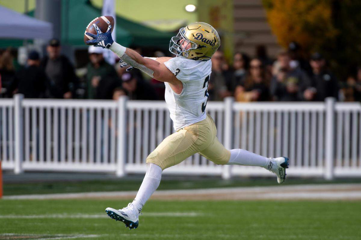 UC Davis Aggies running back Lan Larison (3) catches a ball over the middle in the first half of the 70th Causeway Classic against the Sacramento State Hornets on Nov. 23, 2024 in Sacramento.