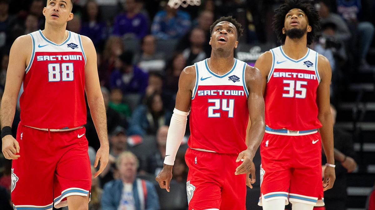 Sacramento Kings forward Nemanja Bjelica (88), Sacramento Kings guard Buddy Hield (24) and Sacramento Kings forward Marvin Bagley III (35) walk to the bench during a time out during a game at Golden 1 Center on Monday, Dec 23, 2019 in {city.}