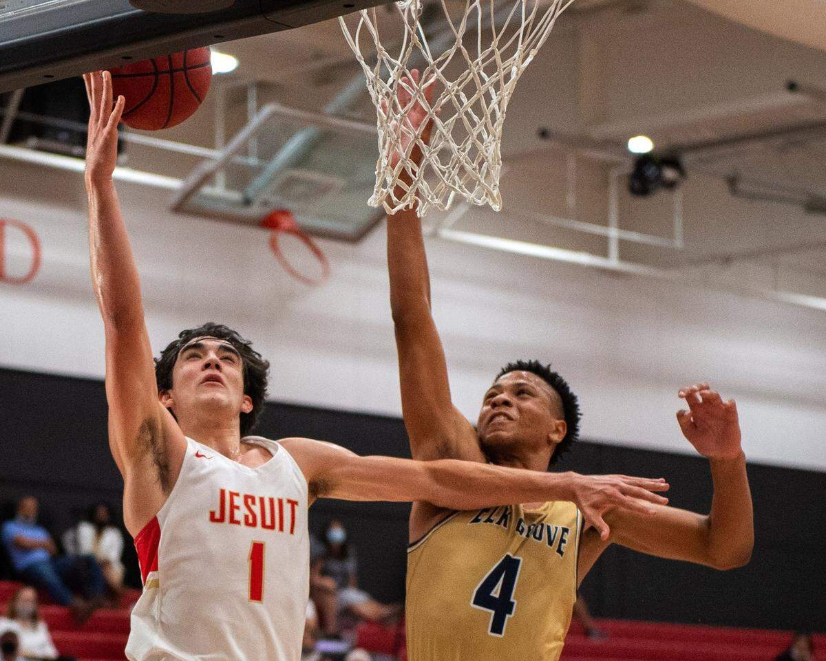 The Jesuit Marauders’ Isa Silva is fouled by the Elk Grove Thundering Herd’s Damar Stewart at Jesuit High School in Carmichael in 2021.