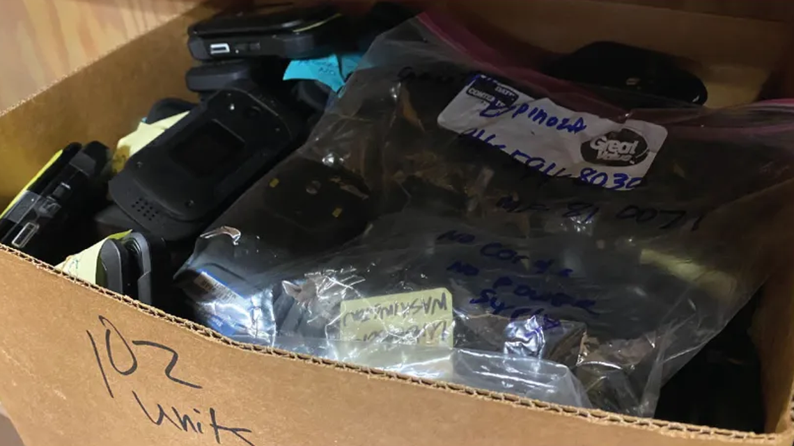 A California State Auditor image of cellphones, some unused for years, that auditors found in a state Employment Development Department office. 