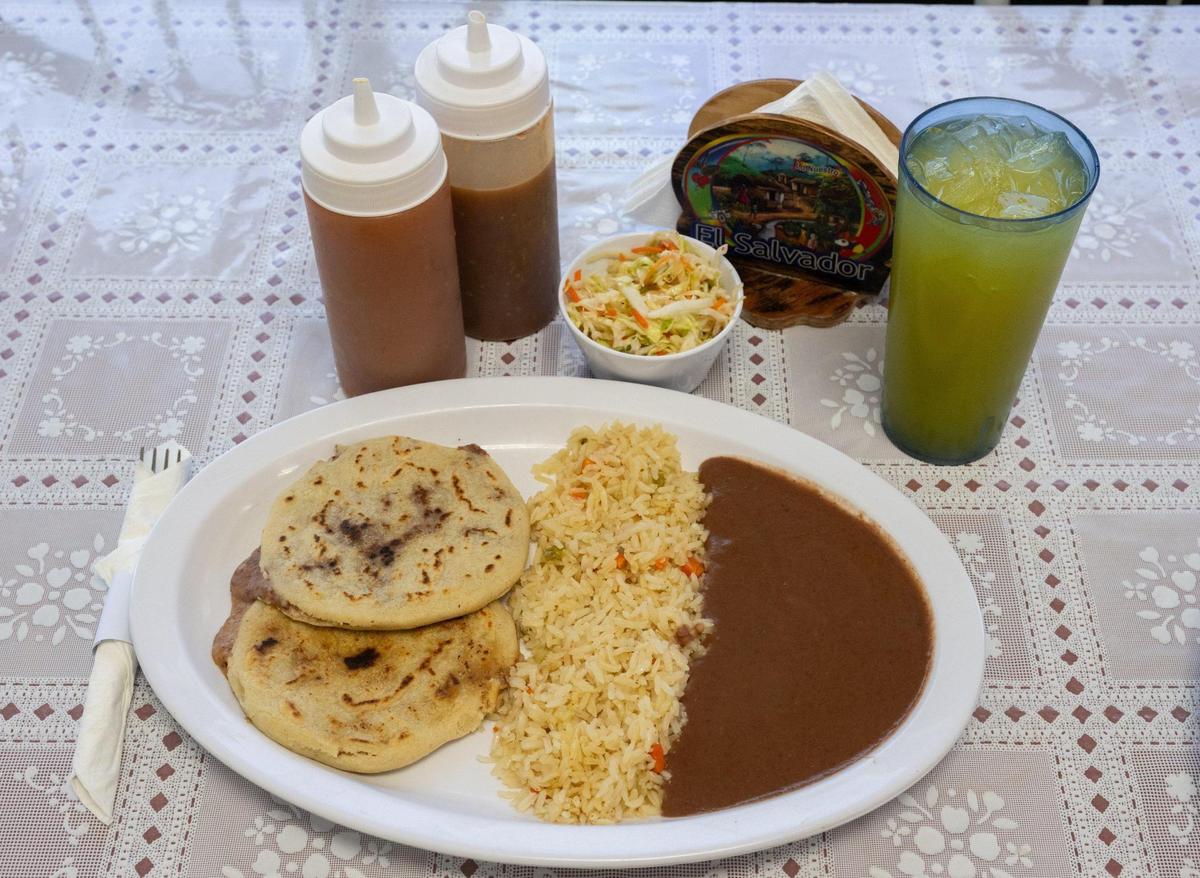A pupusa combo meal ($11.95) that includes two bean-and-cheese pupusas and a side of beans, red rice and pickled cabbage is served at Pupusas Central in Sacramento on Thursday.