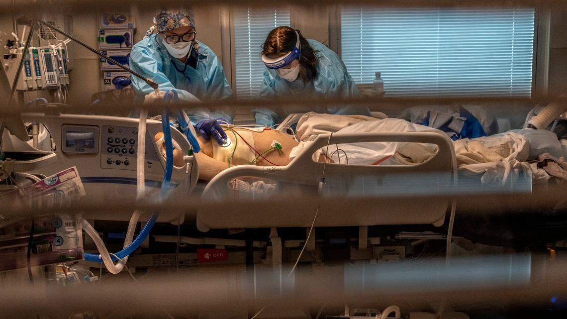 Nurses care for a COVID-19 patient in Roseville in December 2020.
