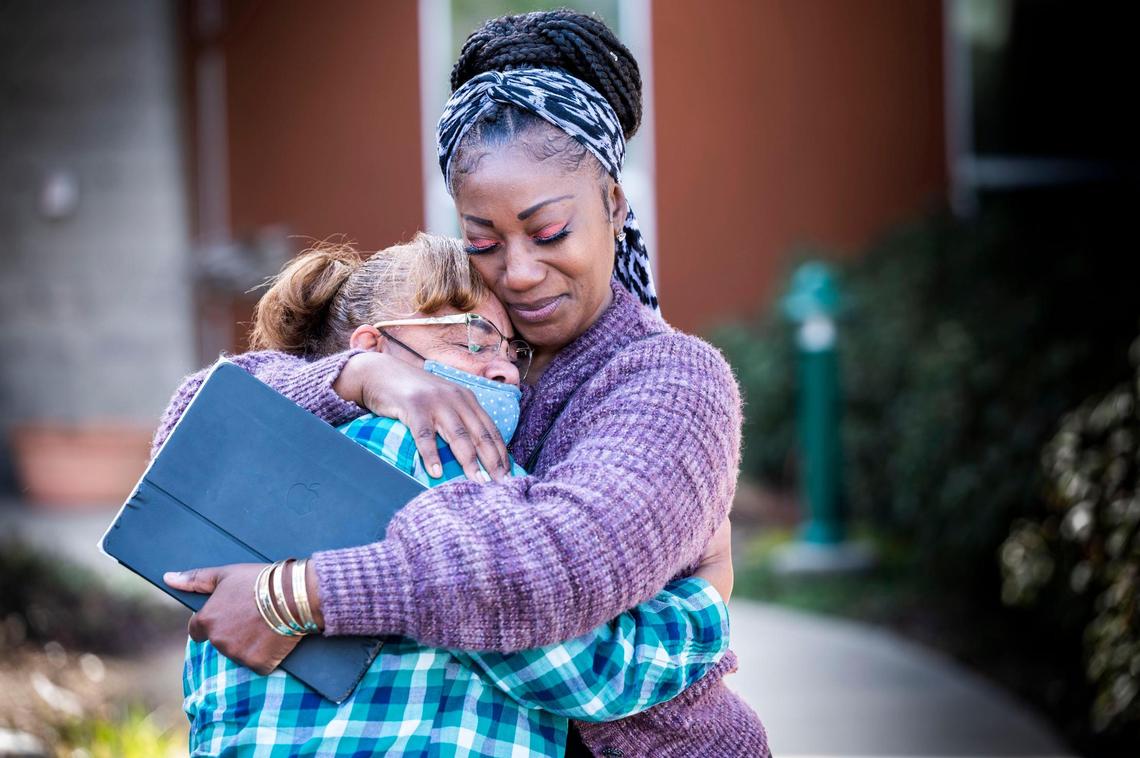 Tina Perry, right, of Sacramento hugs her friend Casandra Clyburn of Bakersfield in front of the El Dorado County District Attorney’s Office in Placerville on Jan. 31, 2022, as they talk about her son Harvest Davidson’s case who has been in jail in El Dorado County for six years.