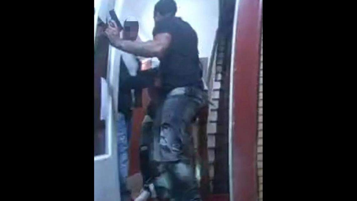 A still from a police bodycam video shows a 20-year-old man in the doorway of a San Jose taqueria holding a handgun he’d seized from a gunman during a fight inside, police said. An officer shot the man when he did not drop the gun as ordered, police said.