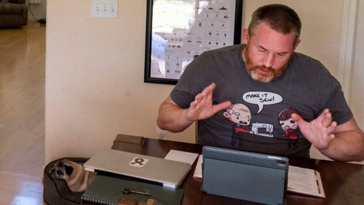 FILE -- Damian Harmony, who teaches Latin at John F. Kennedy High School, record lessons from their home in West Sacramento on Thursday, Aug. 13, 2020. Harmony has been scrutinized after making comments likening parents pushing for reopening to white supremacists.