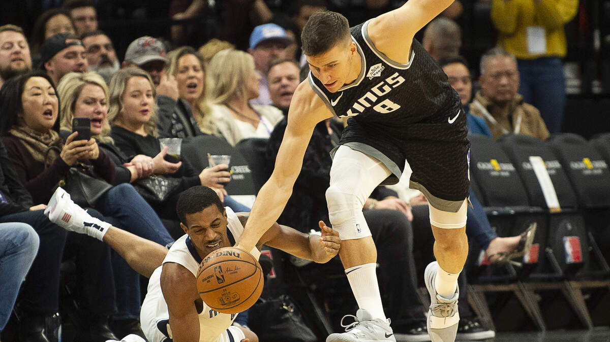 Sacramento Kings guard Bogdan Bogdanovic (8)battle sMemphis Grizzlies guard De’Anthony Melton (0) for ball during game at Golden 1 Center on Thursday, Jan 2, 2020 in Sacramento.